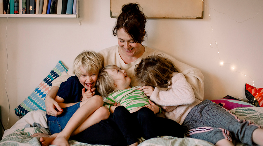 Mother hugging her children