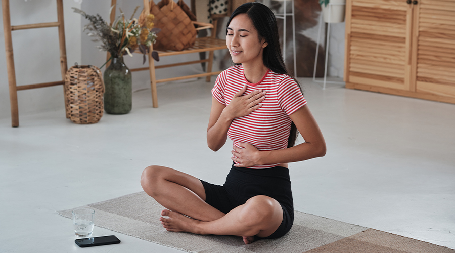 Woman meditating and deep breathing