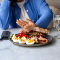 Woman pushing away her plate of food