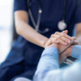 Doctor holding paitent's hand