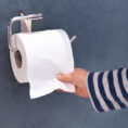 Person grabbing toliet paper