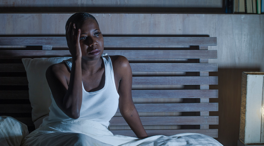 woman who can't sleep sitting up in bed