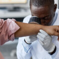 Dermatologist examining patient's arm