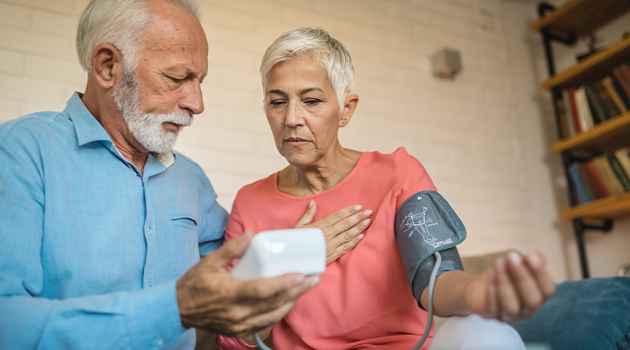 two people checking their blood pressure at home