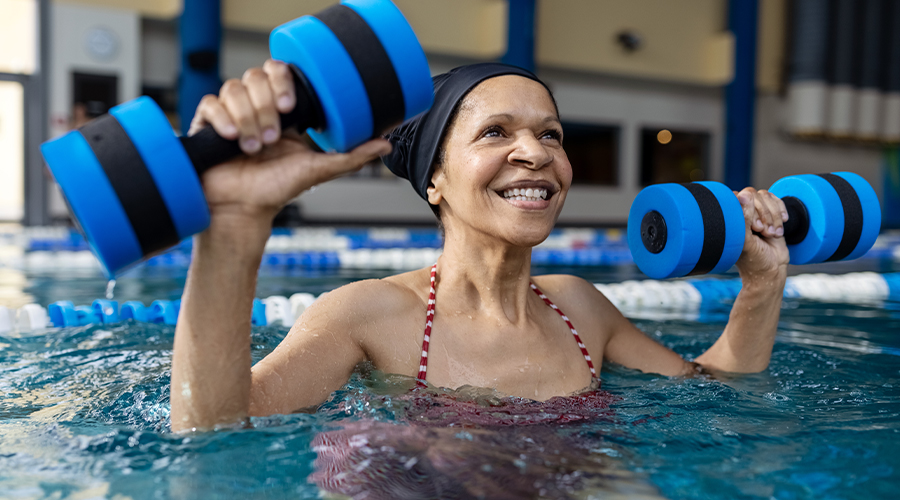 Woman excercising in water aerobic class