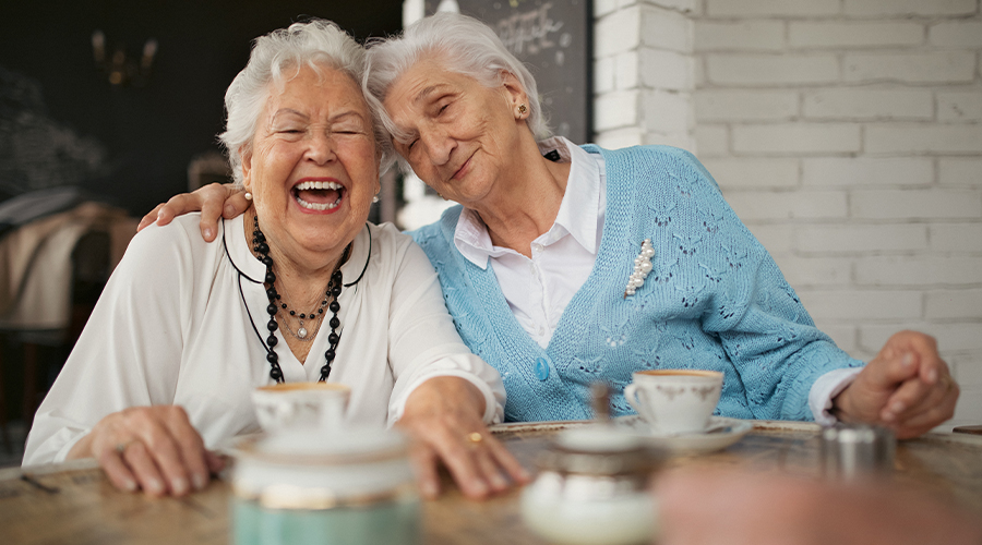 two women laughing at lunch