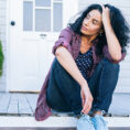 Woman sitting outside looking sad