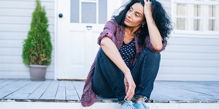 Woman sitting outside looking sad