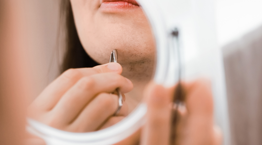 Woman pluking chin hair